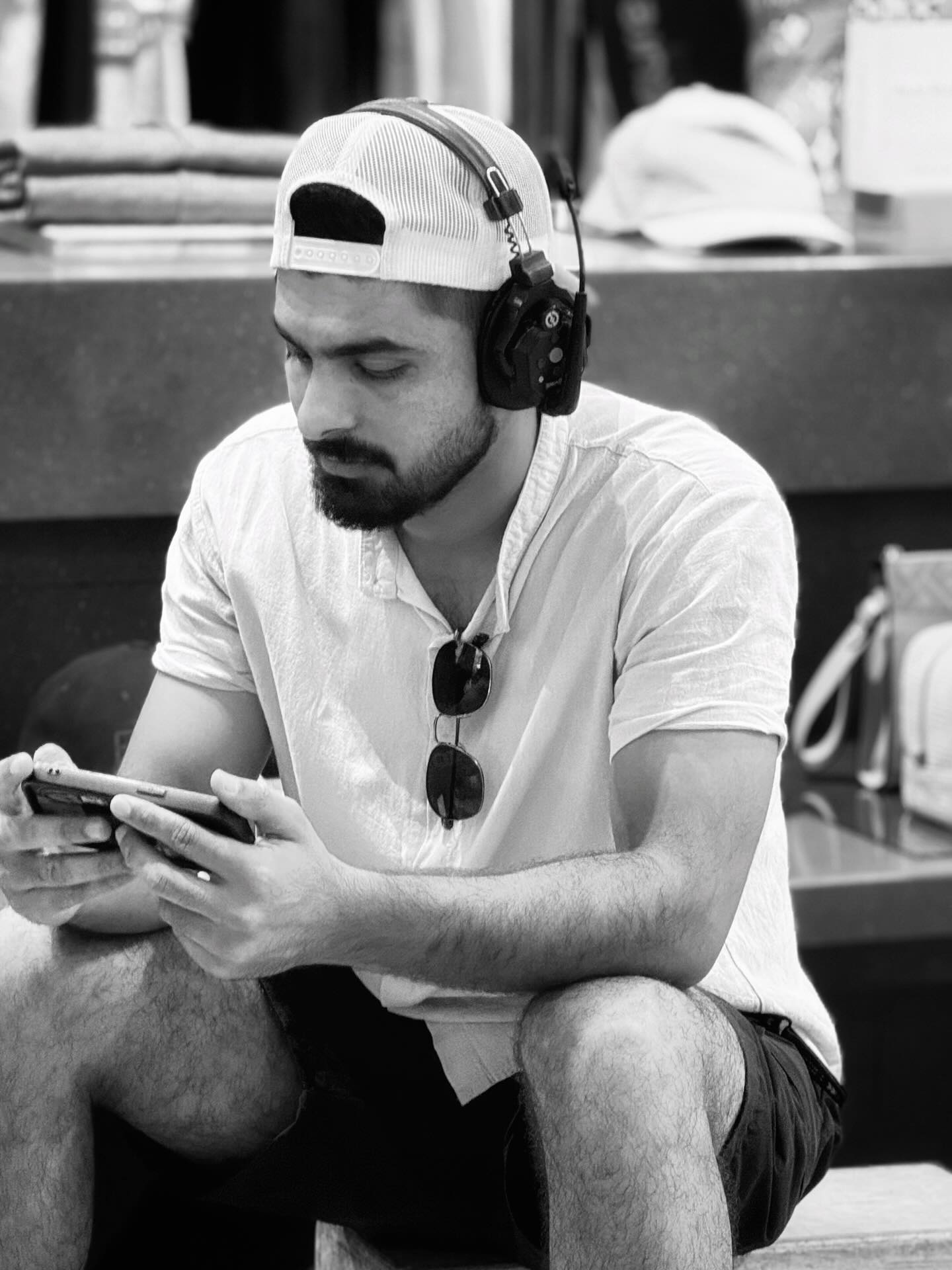 Black and white photo of Umair on comms with a headset