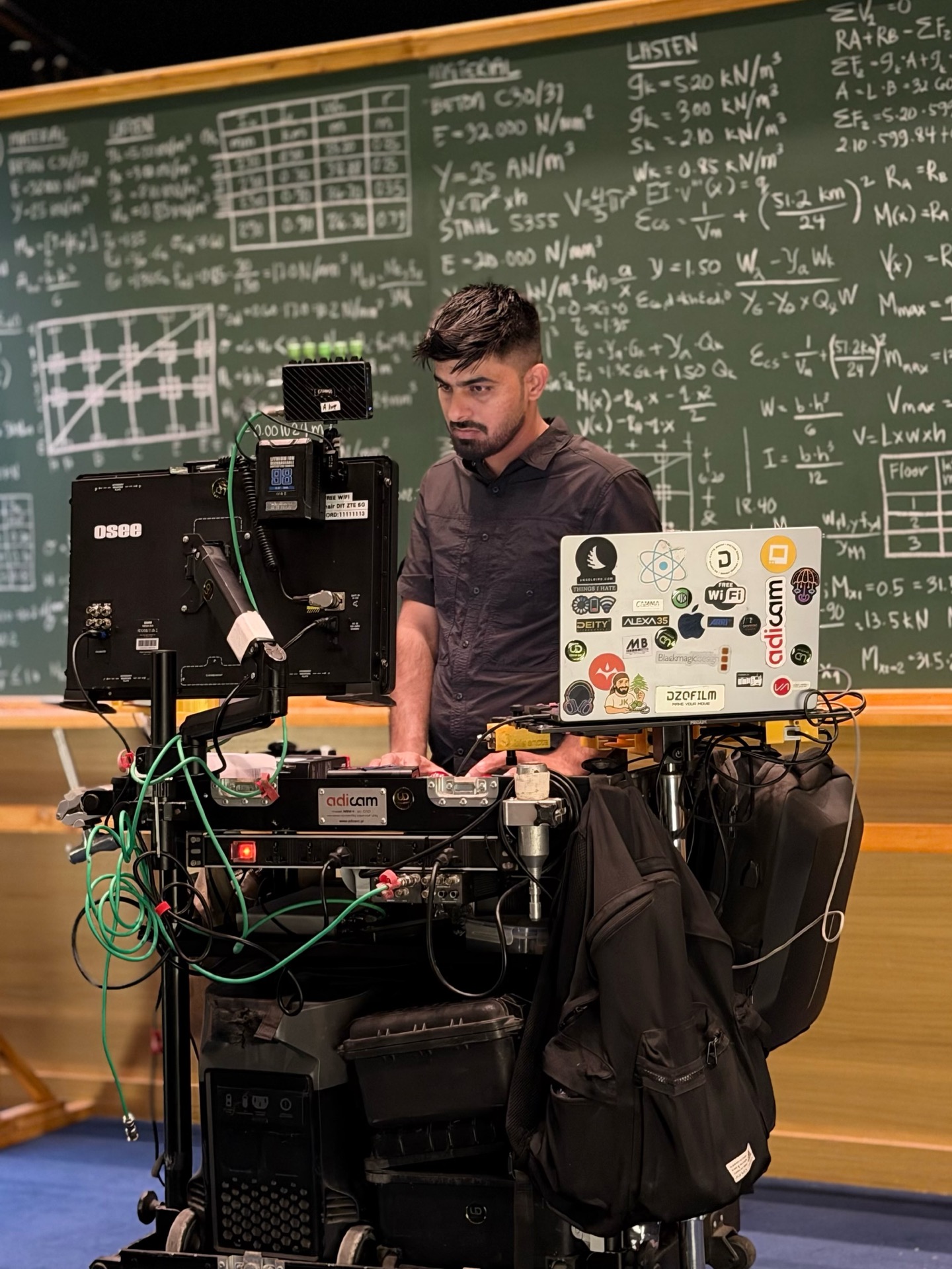 Umair Alam at his DIT cart in a lecture room in front of a chalkboard